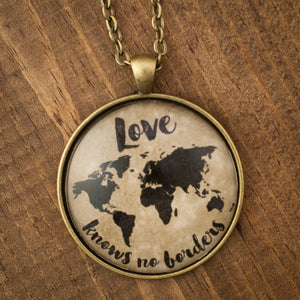 "Love knows no borders" world map necklace
