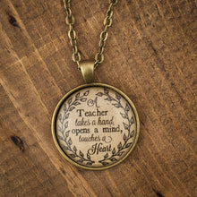 "A teacher takes a hand, opens a mind, touches a heart" necklace
