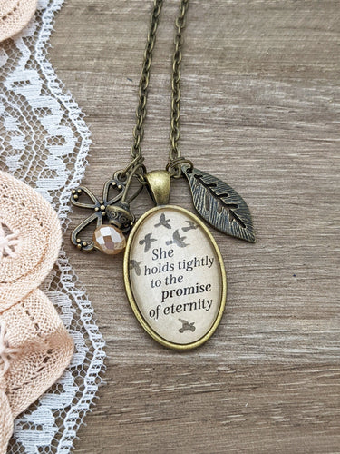 She holds tightly to the promise of eternity. | glass pendant necklace with charms | Mother's Day Gift